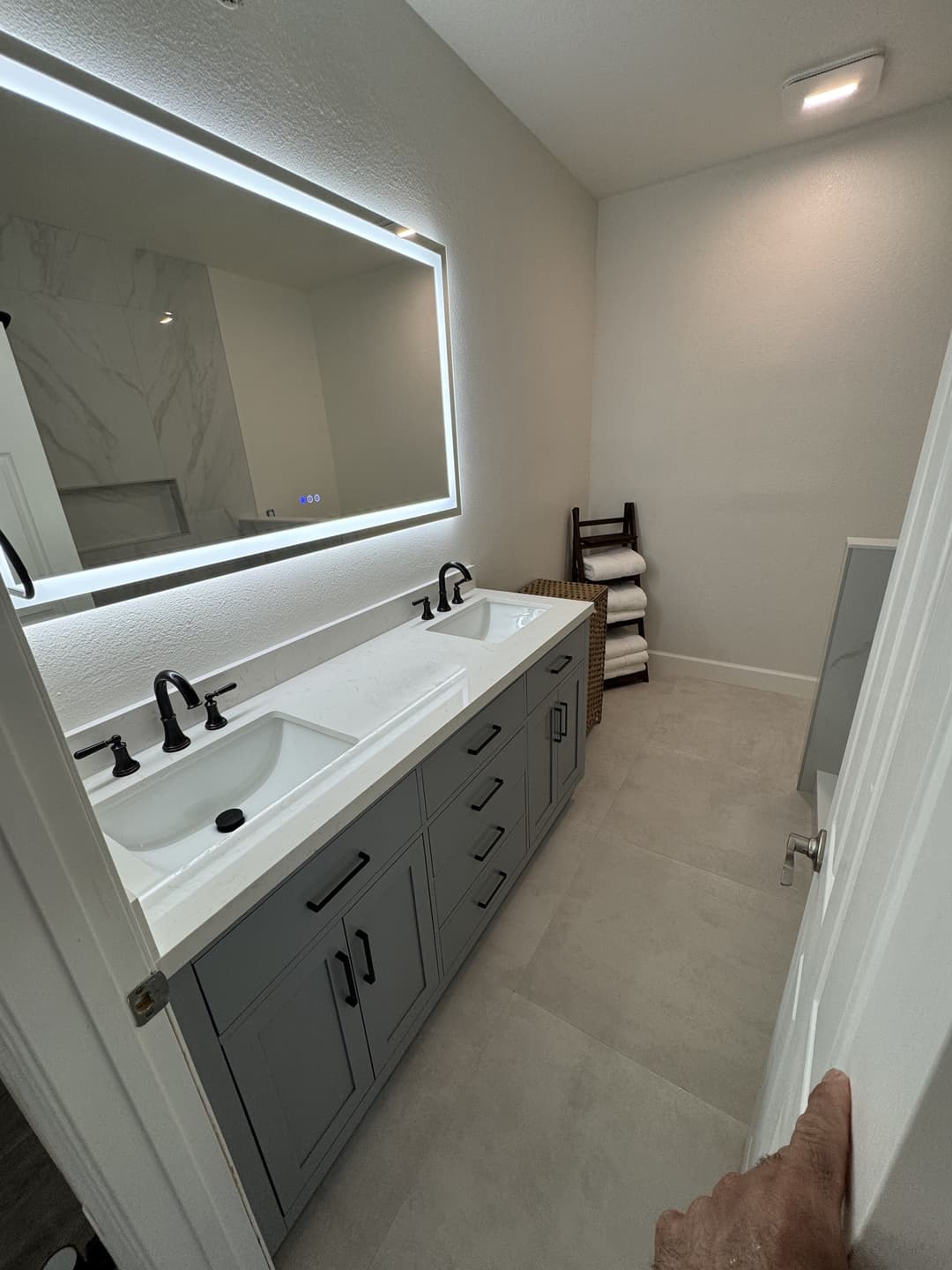 Bathroom remodel with modern vanity, mirror, and updated plumbing fixtures