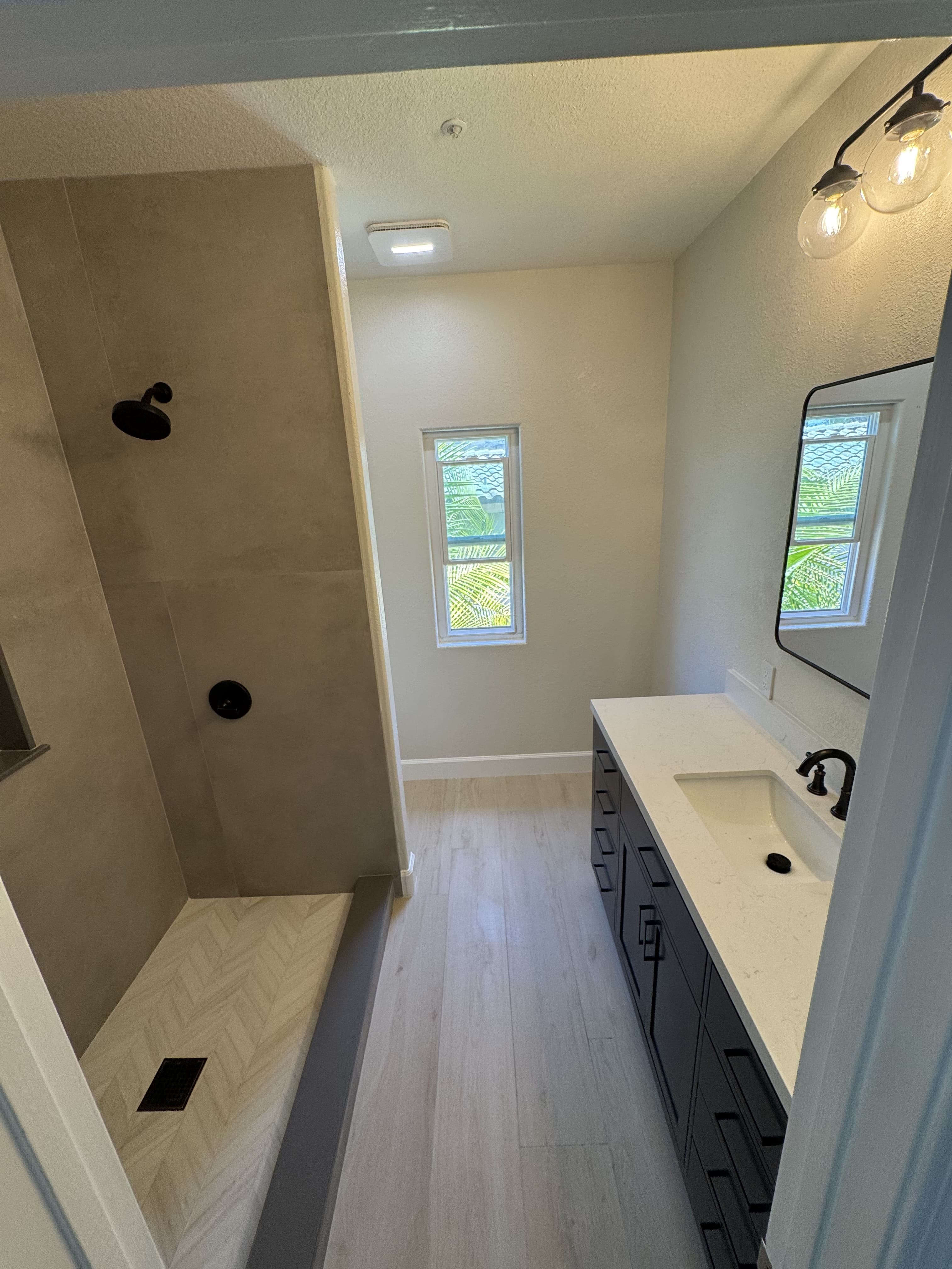 Bathroom remodeling project with walk-in shower, modern vanity, and tile finishes